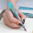 BENU Pixie Aqua Glow Fountain Pen - A Hand Writing On Paper Using A Pen | EndlessPens