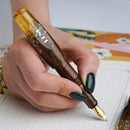 BENU Pixie Honey Bronze Fountain Pen - A Hand Writing On Paper | EndlessPens