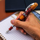 Conklin 1898 Spectra Fusion Burgundy Fountain Pen - Limited Edition (2026) - A Hand Writing on Notebook | EndlessPens