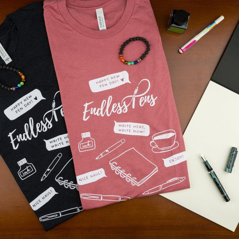 EndlessPens Write Here, Write Now T-Shirt - A Group Of T-Shirts With Pens, Paper, And Ink Bottle | EndlessPens