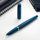 Diplomat Viper Fountain Pen - Blue Fountain Pen and Cap Cover with Notebooks on Table | EndlessPens