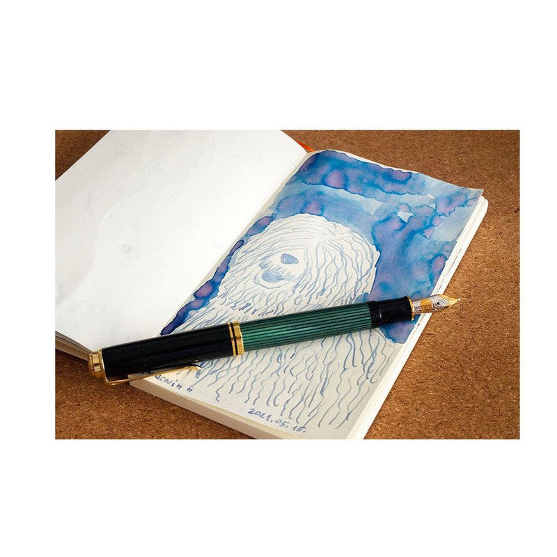 Pennonia Balaton-Kék Balaton-blue Ink Bottle (60ml) - A Fountain Pen On Top Of A Notebook With An Ink Drawing