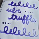 Robert Oster Community Ink Ube Truffle Ink Bottle (50ml) - Purple Writings On Notebook | EndlessPens