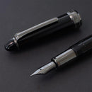 Sailor Naginata Togi Black Trim Fountain Pen - Fountain Pen With Nib Exposed On Black Background | EndlessPens