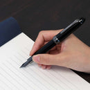 Sailor Naginata Togi Black Trim Fountain Pen - A Person Writing On Notebook | EndlessPens