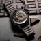 The Electricianz Brown Z Watch - 45mm (Metal Strap Front View On Chocolate Bar)