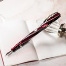 Visconti Divina Elegance Bordeaux Oversize Fountain Pen (14K Gold) - Pen On Top of Notebook | EndlessPens